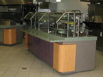 Plastic Laminate Servery Casework with Wood Stand-Off Panels and Solid Surface Countertop with Tray Slides